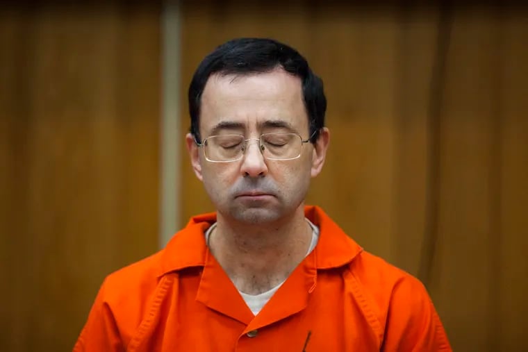 Larry Nassar listens during his sentencing at Eaton County Circuit Court in Charlotte, Mich., in 2018.