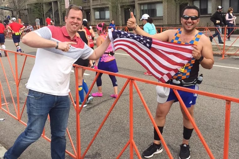Former U.S. Army Sgt. Peter Farley (left) congratulates his Iraqi interpreter Wisam Al-Baidhani, now a U.S. citizen, who ran the Boston Marathon for charity in 2018. Al-Baidhani's family has been awaiting a special visa to enter the U.S. for seven years.