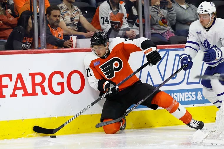 Flyers defenseman Erik Johnson goes after the puck against Toronto Maple Leafs center Bobby McMann on March 14.