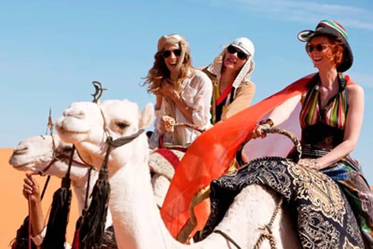 Sarah Jessica Parker, Kim Cattrall and Cynthia Nixon climb aboard camels in "Sex and the City 2." (Warner Bros. Pictures)