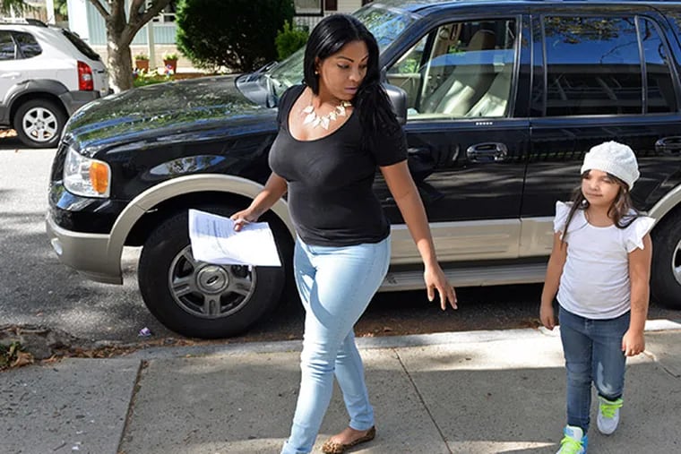 Jovana Acosta and her daughter, Latyana Turchi, arrive at Henry W. Lawton Elementary School to register for kindergarten on September 22, 2014. Latyana hasn't been able to start kindergarten because classes around the city are so full. ( TOM GRALISH / Staff Photographer )