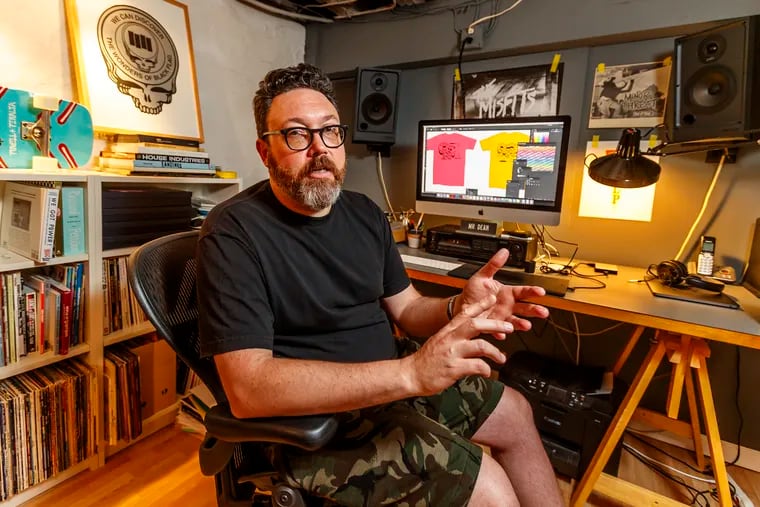 Designer Jeremy Dean sits in his basement workspace in Montgomery County and explains how the "Wonders of Black Flag" came to be. MICHAEL BRYANT / Staff Photographer