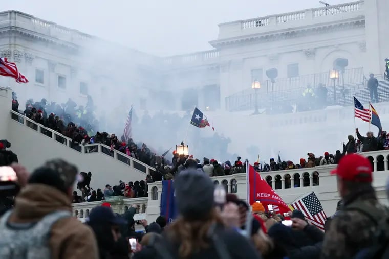 Smoke can be seen outside of the U.S. Capitol while police disperse the crowd hours after a mob of Trump supporters breached the building on Jan. 6, 2021.