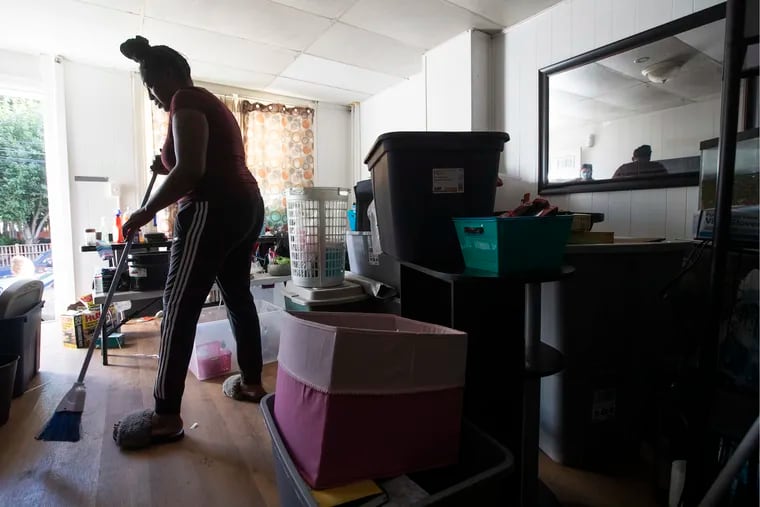 Antoinette Austin-Hunt works cleaning and packing in the Second Street house she and her family rents in Bridgeport, PA on Sept. 7, 2021.   Cleanup continues after tropical storm Ida passed over Philadelphia and region.