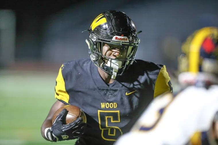 Archbishop Wood’s Nasir Peoples gets past Unionville’s James Hower for a touchdown during the first quarter in PIAA Class 5A semifinals at Northeast High on Friday.