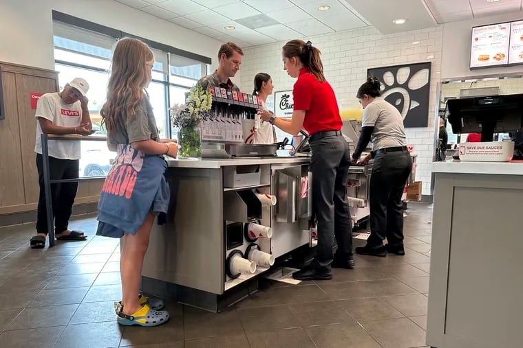 Workers serve customers at a fast food restaurant in southeast Denver on Thursday, June 27, 2024.