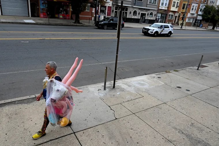 October 18, 2021: Dan Lanzilloti walks north on South Broad Street to his home in South Philly after participating in the Broad Street Run last Sunday. He ran with a unicorn head and two portable "companions" (all in his bag) and a sweatshirt reading, “Men of quality do not fear equality.” He finished 11175th overall, with a time of 2:57:27, but entertained runners along the way saying, “Too much love is never too much.”