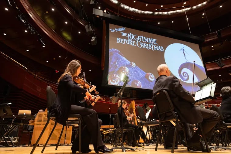 The Philadelphia Orchestra warms up before its live-to-screen performance of the score to Tim Burton's classic film "The Nightmare Before Christmas"  at Verizon Hall on Friday.