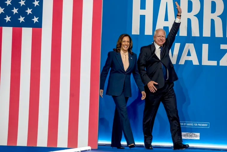 Vice President Kamala Harris, the Democratic presidential nominee, and her running mate, Minnesota Gov. Tim Walz, arrive for a campaign rally at Temple University's Liacouras Center on Aug. 6.