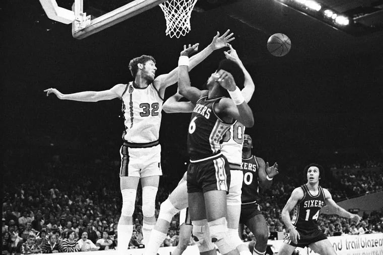 The Trail Blazers' Bill Walton (32) battles for a loose ball with Julius Erving (6) of the Sixers during Game 3 of the NBA Finals on May 29, 1977.