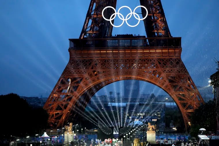 Lights shine under the Eiffel Tower, in Paris during the opening ceremony of the 2024 Summer Olympics.