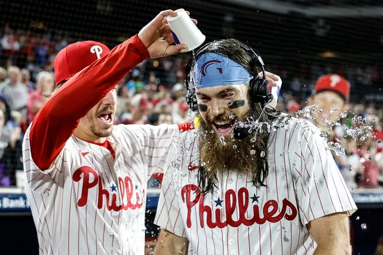 Phillies Bryson Stott left gives Brandon Marsh a water bath after they beat the Cubs 9-6 at Citizens Bank Park in Philadelphia, Wednesday, September 25, 2024