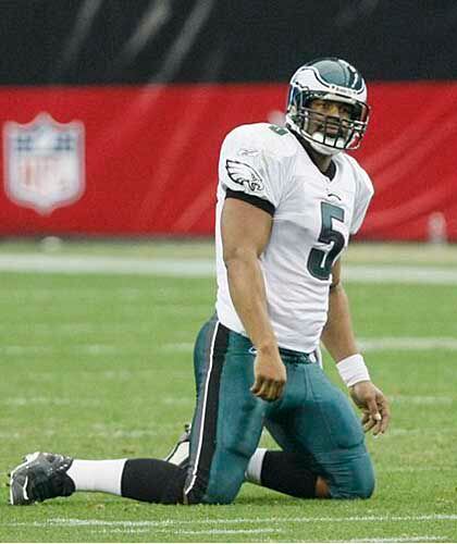 Philadelphia Eagles quarterback Donovan McNabb (5) points to the replay as  he talks with back Judge Greg Wilson during the second quarter against the  Chicago Bears at Soldier Field in Chicago on