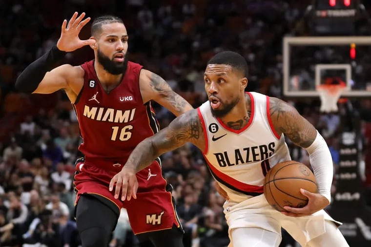 Damian Lillard (right) and the Portland Trail Blazers are an NBA-best 11-2 ATS so far this season, while Caleb Martin (left) and the Miami Heat are tied with the Los Angeles Lakers for the worst point-spread record at 3-10. (Photo by Megan Briggs/Getty Images)