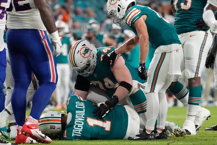 Miami Dolphins quarterback Tua Tagovailoa (1) lies on the field after suffering a concussion during the second half of an NFL football game against the Buffalo Bills, Thursday, Sept. 12, 2024, in Miami Gardens, Fla. (AP Photo/Lynne Sladky)