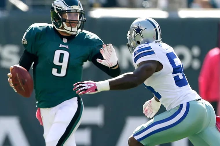 Nick Foles (9) runs with the ball with Dallas Cowboys outside linebacker Bruce Carter (54) in pursuit during the first half of an NFL football game, Sunday, Oct. 20, 2013, in Philadelphia. (Matt Rourke/AP file)