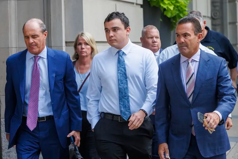 Philadelphia police officer Mark Dial, center, arrives at the Juanita Kidd Stout Center for Criminal Justice in Philadelphia, on Sept. 19, 2023, with attorneys for a bail hearing. Brian McMonigle is at left and at right is Fortunato Perri Jr.