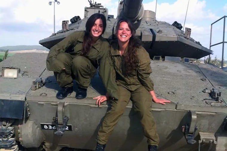 Cpl. Yael Shamir (left) on a tank with fellow tank instructor, Keren Gavriel. (photo courtesy of Yael Shamir)