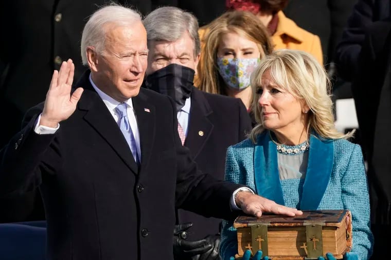 Joe Biden is sworn in as the 46th president of the United States by Chief Justice John Roberts as Jill Biden holds the Bible during the 59th Presidential Inauguration at the U.S. Capitol in Washington, Jan. 20, 2021.