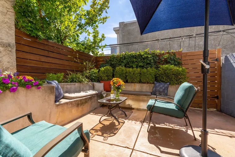 The living room opens to a private backyard patio.