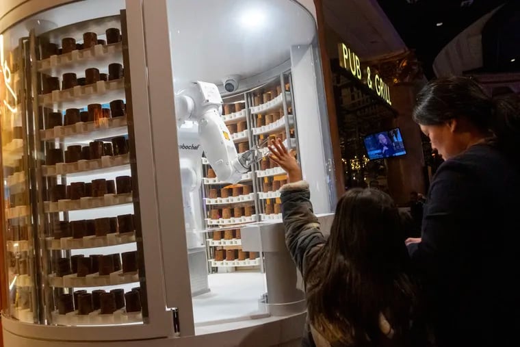 A child waved to a robot dessert booth at the annual CES technology trade show in Las Vegas in January. Trade shows can be a gamble for small-business owners, but they can also benefit them.