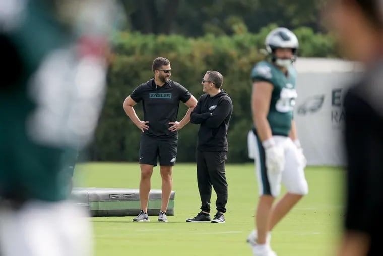 Eagles head coach Nick Sirianni (left) and GM Howie Roseman (right) talk during Eagles training camp at the NovaCare Complex on Sunday, Aug. 18, 2024.