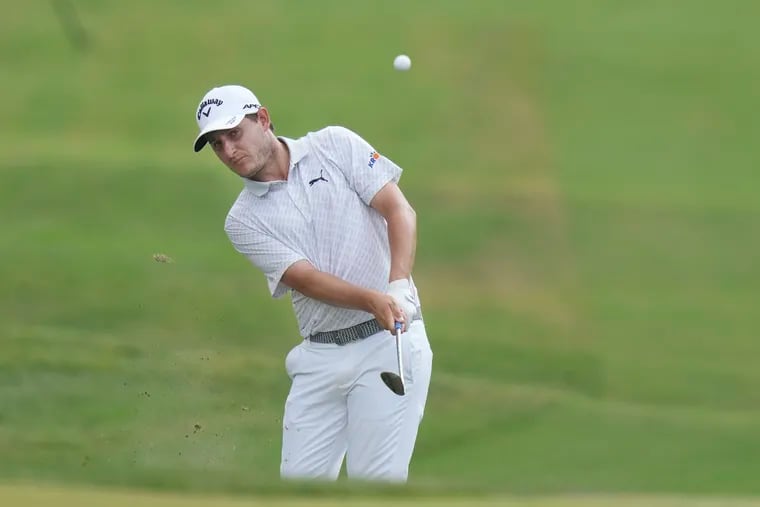 FILE - Emiliano Grillo, of Argentina, hits an approach shot on the 18th hole during the final round of the Charles Schwab Challenge golf tournament at Colonial in Fort Worth, Texas, May 28, 2023. Grillo had to go to playoff last year after a double boey, when his wayward tee shot went into the flowing water of a small concrete drainage canal to the right of the 18th fairway. The ball finally came to rest against a rock in the middle of the flow about 150 yards downstream. (AP Photo/LM Otero, File)