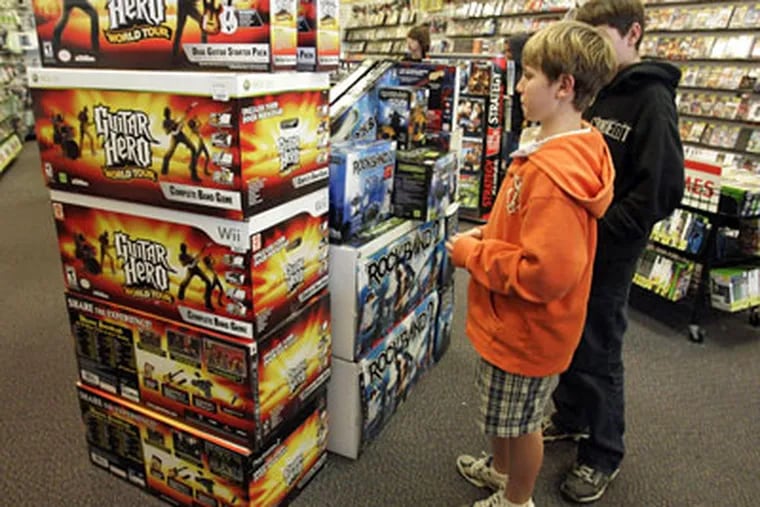 "Guitar Hero" and "Rock Band 2" video game bundles are seen on display at a GameStop store. As the music industry struggles to cope with falling CD sales, the music video games are helping revive interest in music and providing a lift to sales. (AP Photo / Paul Sakuma)