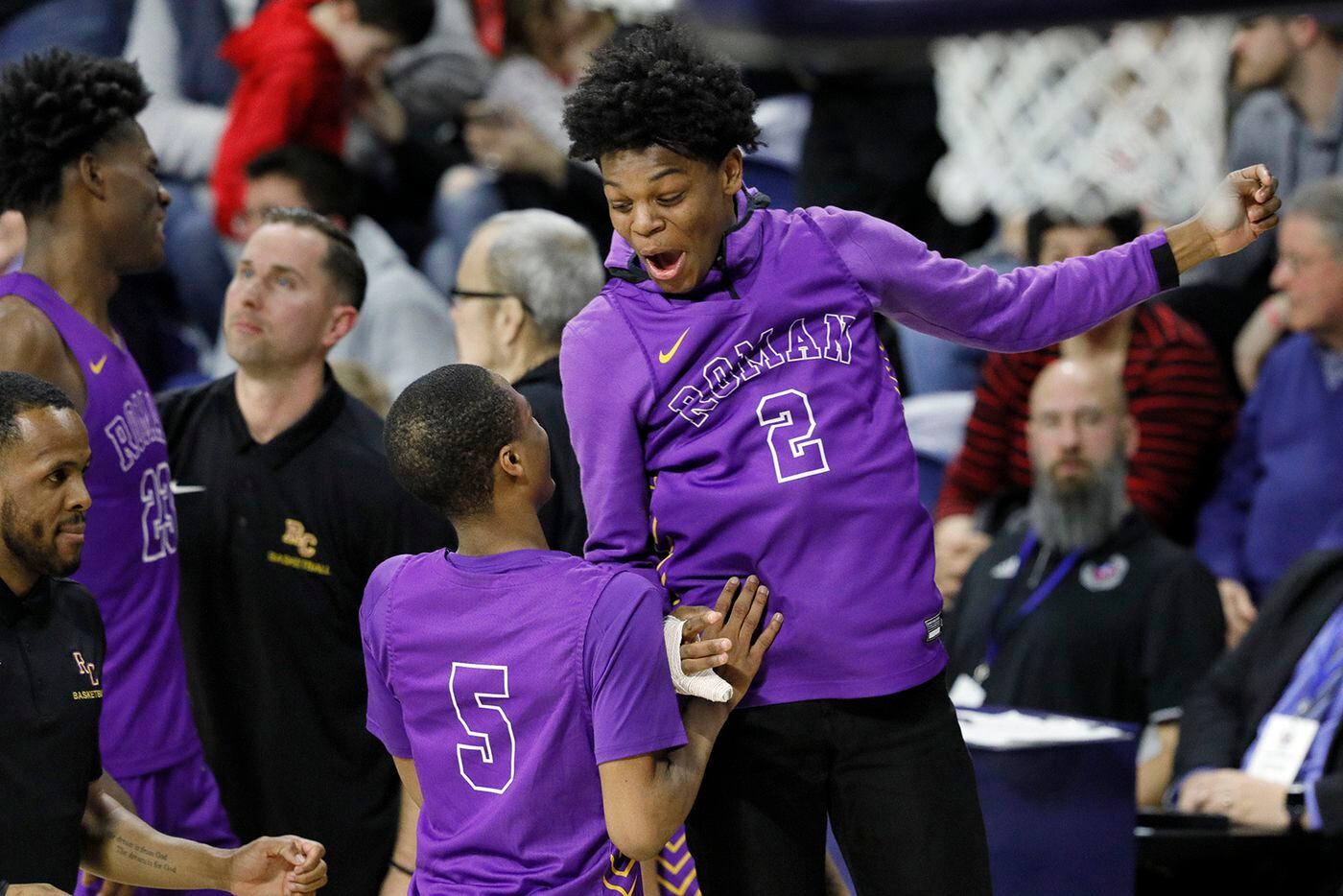 Roman Catholic’s Xzayvier Brown (No. 5) and Jhamir Martin celebrate after the Cahillites' 83-73 win over Archbishop Wood. 