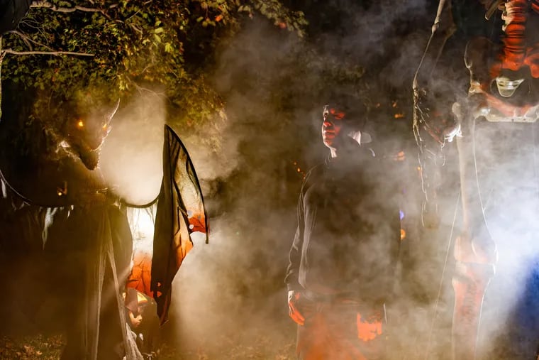 Mike Kane stands in his yard in West Chester. The software engineer, who founded the Halloween haunt-finder app FrightMaps, has spent $5,000 on an elaborate Halloween display that includes animatronics, lighting, projectors, and fog machines.