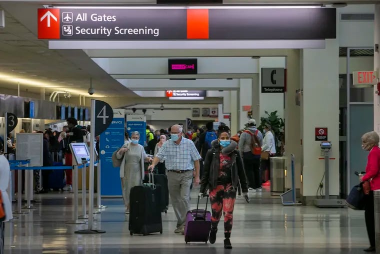 Travelers made their way through Terminal C on Wednesday in preparation for boarding a flight out of Philadelphia International Airport.