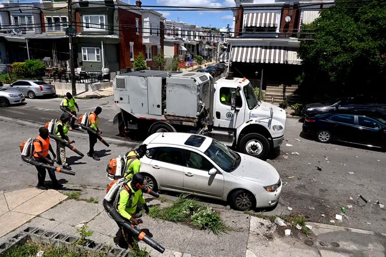 As part of Mayor Parker's “Clean and Green” initiative Streets department workers are on task at South 55th and Elliot Streets in Kingsessing at the beginning of July.