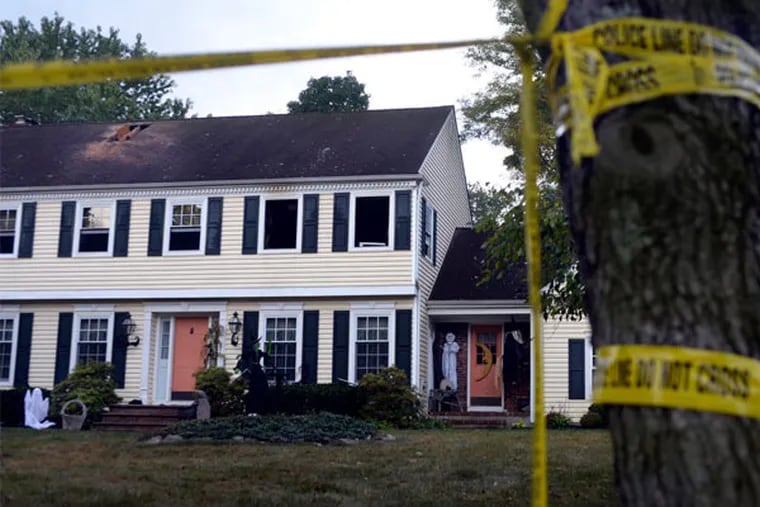 Crime scene tape cordons the house where John P. Sheridan Jr., president and CEO of the Cooper University Health System, and his wife wife, Joyce, were found dead after a fire Sunday. (Tom Gralish / Staff Photographer)