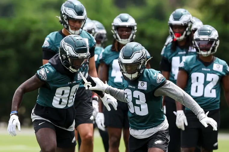 Parris Campbell (left) and John Ross run drills during minicamp on Wednesday. The speedy duo leads the race for the Eagles' third wide receiver spot.