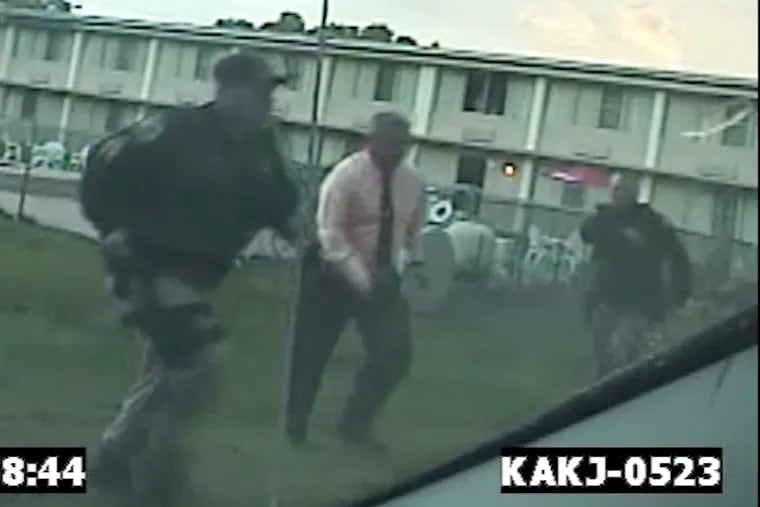 Former Bordentown Township Police Chief Frank Nucera Jr., (pink shirt) is seen on police dashcam responding to a 9-1-1 call at a motel in September 2016. Nucera, who faces a federal hate trial, is accused of assaulting a young black man at the motel during an arrest.