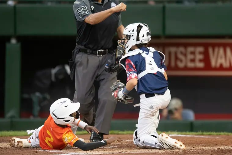Media catcher, Nathaniel Saleski, right tags out on home plate  Needville’s Jakolby White,  in the 2nd inning of 2023 Little League Baseball World Series game at Lamade stadium in South Williamsport, PA.