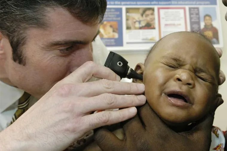 Pediatrician Daniel Taylor examines a baby at St. Christopher's Hospital for Children in Philadelphia.