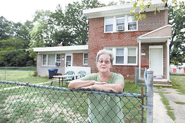 Rosemary Roberts stands in front of her home at 346 South Martin Ave in Mount Holly, NJ . The homes that use to surround it have been torn down and the township of Mount Holly says they will only pay her $55,000 for her home, even though she says she has been paying property taxes on it after it was assessed for $98,000. (Michael Bryant / Staff Photographer)