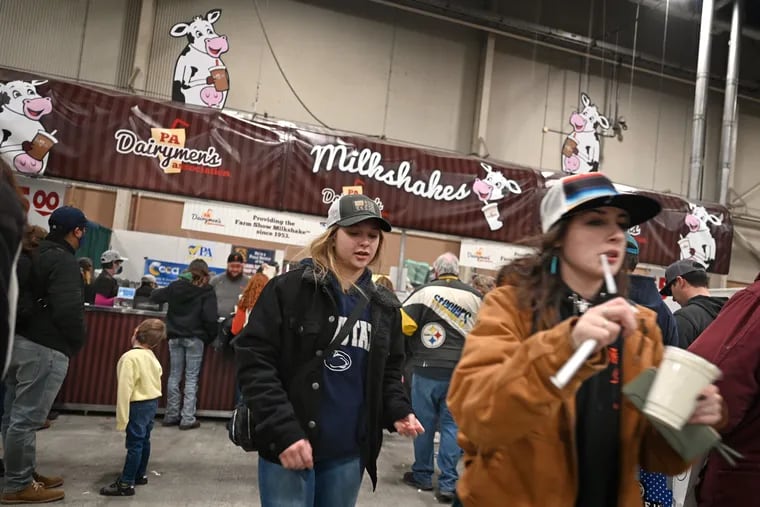 Attendees visit the the PA Dairymen’s Association milkshake booth at the Pennsylvania Farm Show in Harrisburg Jan. 10, 2022.