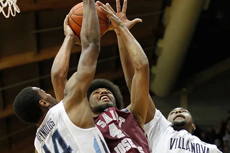 DeAndre Bembry has his shot blocked at the rim by a pair of Villanova defenders. (Ron Cortes/Staff Photographer)